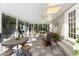Bright sunroom with tile floors, wicker furniture and lots of natural light at 560 Parker Creek Rd, Holly Springs, NC 27540