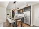 Well-appointed kitchen with a dining table, stainless steel appliances and dark cabinets at 601 W Rosemary St # 715, Chapel Hill, NC 27516