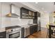 Modern kitchen featuring stainless steel appliances, dark cabinetry, and white subway tile backsplash at 601 W Rosemary St # 715, Chapel Hill, NC 27516
