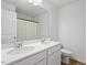 Bright bathroom features a double sink vanity with white countertops and modern fixtures with a mirror at 637 Marrian Dr, Clayton, NC 27520
