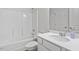 Clean bathroom featuring white tiled tub/shower combination, white vanity with quartz countertops, and white trim at 637 Marrian Dr, Clayton, NC 27520
