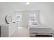 This neutrally decorated bedroom has a long dresser, a single bed and two windows at 637 Marrian Dr, Clayton, NC 27520