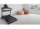Bonus room featuring a carpeted floor, treadmill, two beanbag chairs and a window at 637 Marrian Dr, Clayton, NC 27520