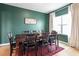 Dining room features a dark wood table, eight chairs, a large window, and an area rug at 637 Marrian Dr, Clayton, NC 27520