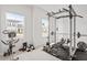 Spacious exercise room with weightlifting equipment and bright, natural light from the windows at 637 Marrian Dr, Clayton, NC 27520