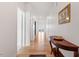 Inviting hallway featuring gleaming hardwood floors and elegant console table at 637 Marrian Dr, Clayton, NC 27520