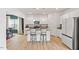 Bright kitchen features stainless appliances, center island with bar stool seating, and granite countertops at 637 Marrian Dr, Clayton, NC 27520