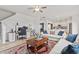 Open-concept living room with kitchen view, neutral furniture, and hardwood floors at 637 Marrian Dr, Clayton, NC 27520