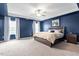 Large main bedroom with tray ceiling, an area rug, and ensuite bathroom at 637 Marrian Dr, Clayton, NC 27520