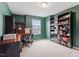 Office with dark wood bookshelves, desk, chair, and carpeted floor at 637 Marrian Dr, Clayton, NC 27520