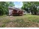 View of the backyard featuring a spacious deck, a staircase, and a well-manicured lawn at 687 W Watson Rd, Benson, NC 27504