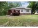The backyard features an expansive deck and mature trees, great for outdoor gatherings at 687 W Watson Rd, Benson, NC 27504