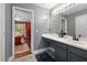 Bathroom featuring gray vanity and view into bedroom at 687 W Watson Rd, Benson, NC 27504