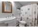 Cozy bathroom featuring a stylish sink, ornate mirror and a tub with a decorative shower curtain at 687 W Watson Rd, Benson, NC 27504