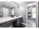 Stylish bathroom with gray cabinetry, patterned tile floors, and decorative lighting at 687 W Watson Rd, Benson, NC 27504