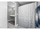 Bathroom with patterned tile floors, gray vanity, and shower with patterned curtain at 687 W Watson Rd, Benson, NC 27504
