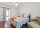 Bedroom with hardwood floors, ceiling fan, and sliding door to bathroom at 687 W Watson Rd, Benson, NC 27504