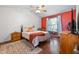 Bright bedroom with ceiling fan, hardwood floors, and cozy decor at 687 W Watson Rd, Benson, NC 27504