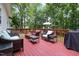 Relax on the spacious deck featuring comfortable seating and a beautiful wooded view at 687 W Watson Rd, Benson, NC 27504