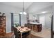 Cozy dining area with stylish table setting, chandelier, and kitchen view at 687 W Watson Rd, Benson, NC 27504
