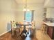 Dining room with floral chairs, wood floors, and a view of the kitchen at 687 W Watson Rd, Benson, NC 27504