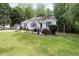 Well-maintained home featuring lush landscaping, a storage shed, and a manicured lawn at 687 W Watson Rd, Benson, NC 27504