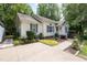 Charming single-story home with a well-manicured lawn, mature trees, and a long driveway at 687 W Watson Rd, Benson, NC 27504