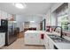 Bright kitchen featuring stainless steel appliances, white cabinetry, and an open layout at 687 W Watson Rd, Benson, NC 27504