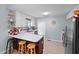 Kitchen features a breakfast bar, white cabinetry, stainless steel appliances, and tile backsplash at 687 W Watson Rd, Benson, NC 27504