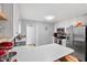 Bright kitchen features white cabinets, stainless steel appliances, a kitchen island, and neutral countertops at 687 W Watson Rd, Benson, NC 27504
