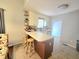 Cozy kitchen with an island, seating, and a view of the adjacent breakfast nook at 687 W Watson Rd, Benson, NC 27504