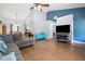 Open-concept living area with a vaulted ceiling, wood floors, and seamless flow to dining and kitchen at 687 W Watson Rd, Benson, NC 27504