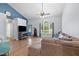 Comfortable living room features hardwood floors, a ceiling fan, and a large window, creating a cozy and inviting atmosphere at 687 W Watson Rd, Benson, NC 27504