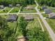 Aerial view of home in serene neighborhood with fenced yard, lush lawn and mature trees at 7801 Charters End St, Willow Springs, NC 27592
