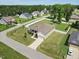 Well-manicured lawns surround this home with a covered porch, white picket fence and mature trees at 7801 Charters End St, Willow Springs, NC 27592