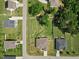 Aerial view of fenced backyard featuring mature trees, lush lawns, and privacy at 7801 Charters End St, Willow Springs, NC 27592