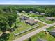 Aerial view showcasing home with fenced yard, lush lawn, mature trees in a serene neighborhood at 7801 Charters End St, Willow Springs, NC 27592