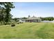 Expansive backyard features a greenhouse, a raised garden, and a cozy screened-in patio at 7801 Charters End St, Willow Springs, NC 27592