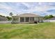 Expansive backyard with a well-maintained lawn, a covered patio, and plenty of space at 7801 Charters End St, Willow Springs, NC 27592