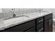 Bathroom features a double vanity with granite countertop, dark cabinets and modern faucets at 7801 Charters End St, Willow Springs, NC 27592