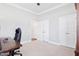 Spacious bedroom with crown molding, double doors, and carpet flooring at 7801 Charters End St, Willow Springs, NC 27592