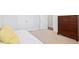 This bedroom showcases a wooden dresser complemented by white closet doors and neutral carpeting at 7801 Charters End St, Willow Springs, NC 27592