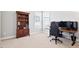 Well-lit bedroom with a spacious desk setup, wooden bookcase and neutral carpet at 7801 Charters End St, Willow Springs, NC 27592