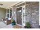 Charming front entrance with stone facade, decor, seating, and a 'Welcome' mat that offers an inviting ambiance at 7801 Charters End St, Willow Springs, NC 27592