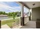 Inviting front porch with stone supports and an American flag in the distance creates a welcoming curb appeal at 7801 Charters End St, Willow Springs, NC 27592