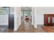 Bright hallway with hardwood flooring and decorative wall paneling, leading to a spacious living area at 7801 Charters End St, Willow Springs, NC 27592