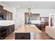 Kitchen with central island, granite counters, stainless steel appliances, and a sink with modern fixtures at 7801 Charters End St, Willow Springs, NC 27592