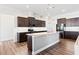 Well-equipped kitchen features granite countertops, stainless steel appliances, central island, and wooden cabinets at 7801 Charters End St, Willow Springs, NC 27592