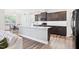 Modern eat-in kitchen with gray island, granite countertops, stainless steel appliances, and wooden cabinets at 7801 Charters End St, Willow Springs, NC 27592