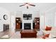 Well-decorated living room featuring a fireplace, hardwood floors, and comfortable seating arrangement for an inviting ambiance at 7801 Charters End St, Willow Springs, NC 27592